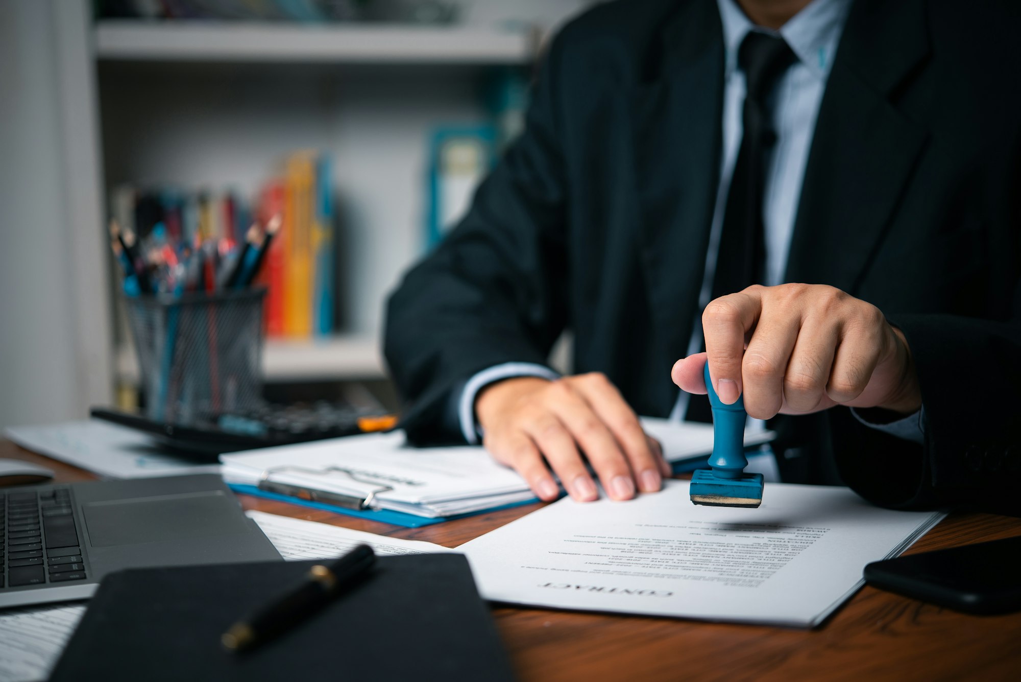 Hand man stamping documents notary public in office . Businessperson stamping approval