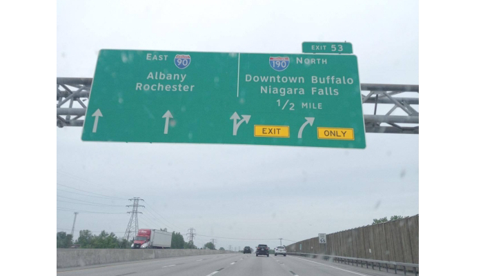 a green sign on a highway