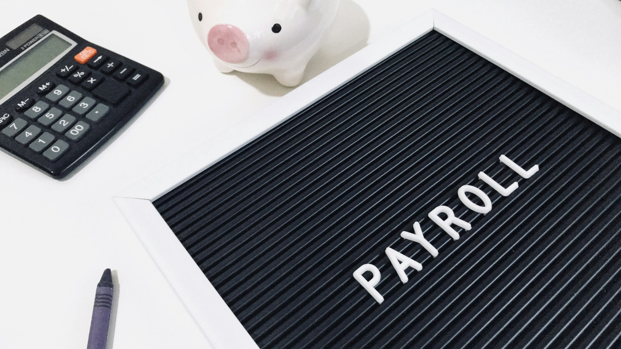 a black letter board with white letters on it next to a piggy bank